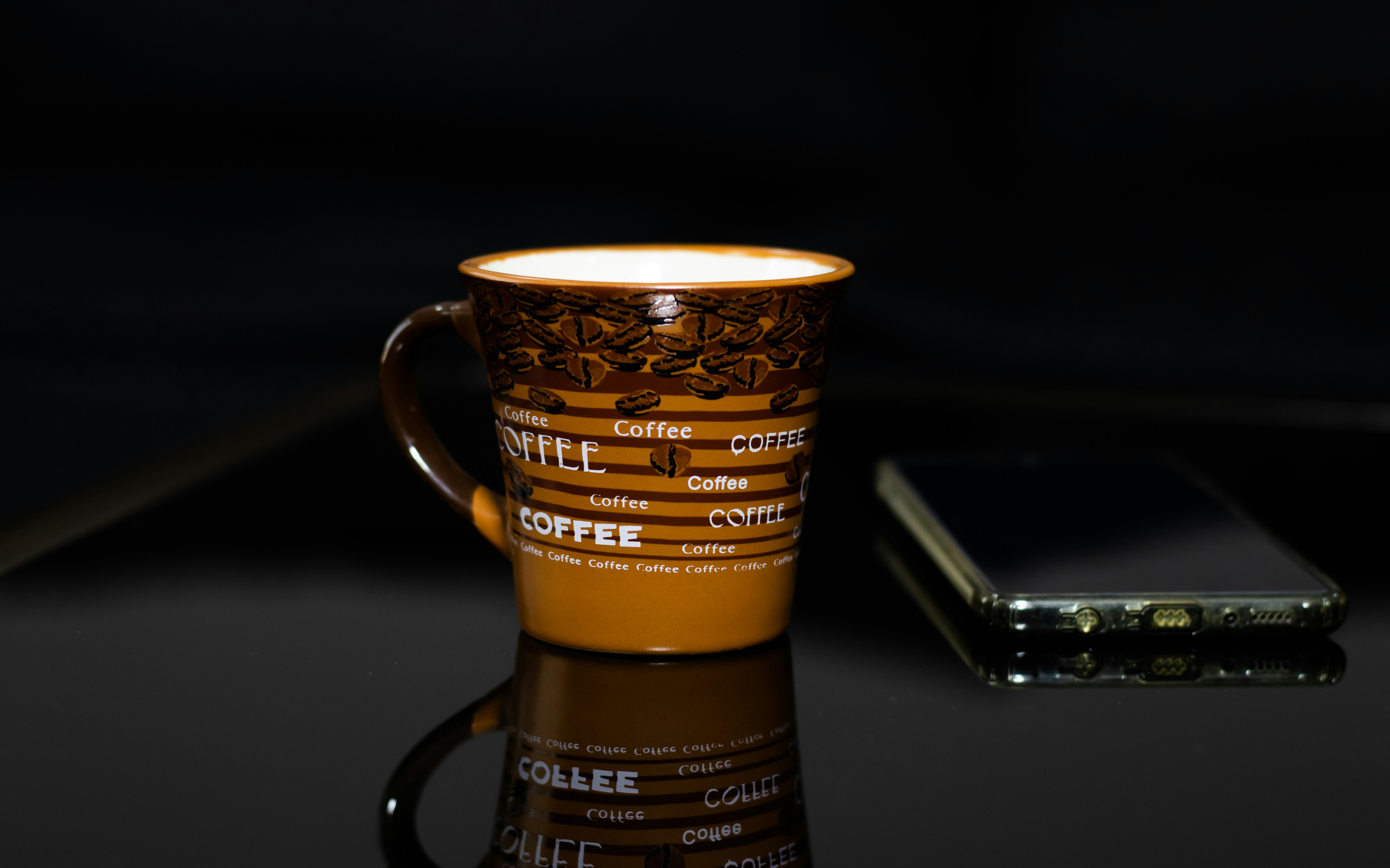Assorted custom coffee cups displaying vibrant, eye-catching designs.