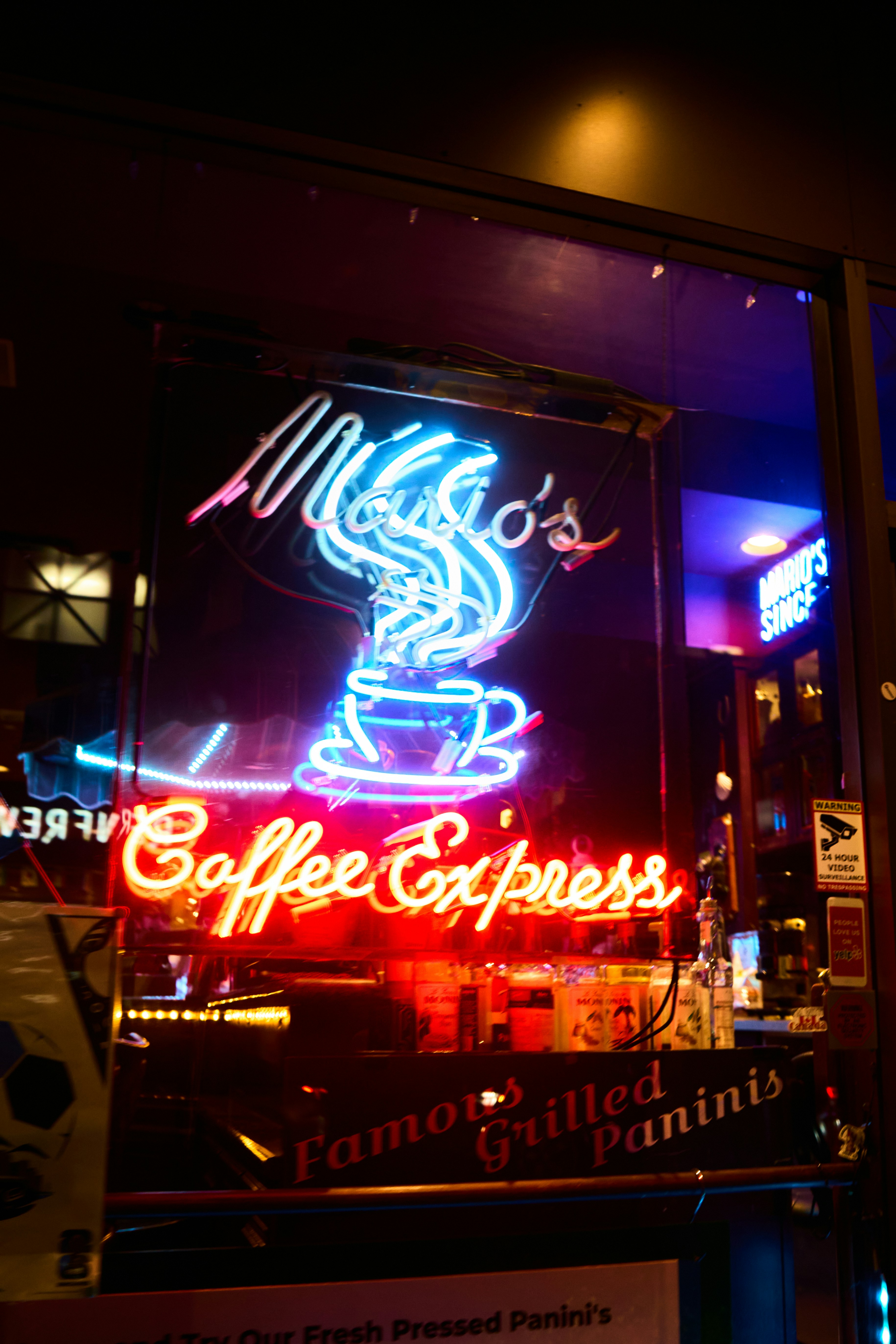 Smiling customers enjoying coffee in a vibrant café with custom mugs.
