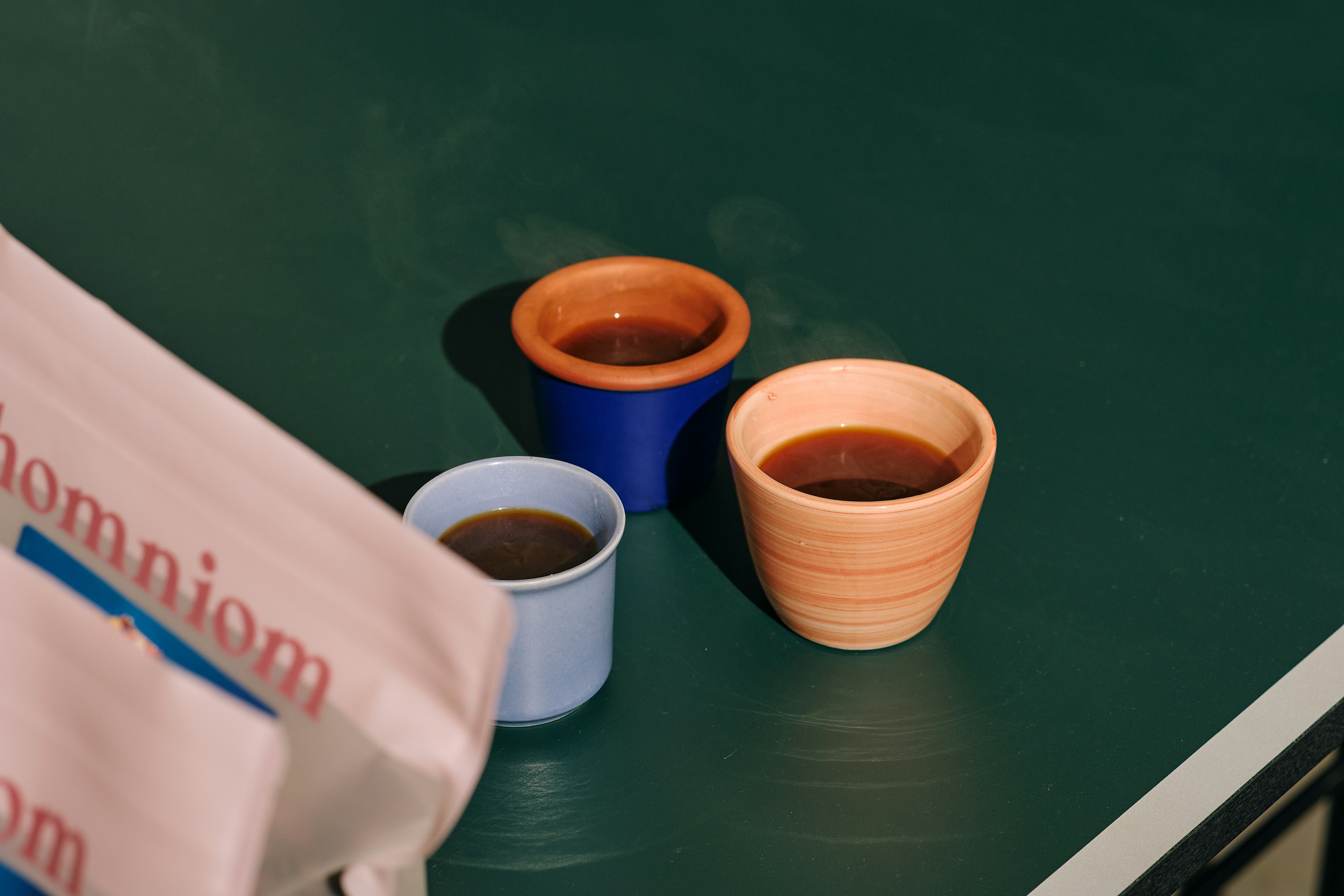 Design process of custom coffee cups with sketches and color samples.